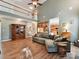 Bright, open living room with high ceilings, a staircase, an adjacent eat-in kitchen and a sectional sofa at 1564 Trippett Nw St, Concord, NC 28027