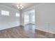 Bright dining room featuring hardwood floors, decorative wainscoting and an open doorway at 1636 Red Leaf Dr, Fort Mill, SC 29715