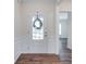 Bright foyer features dark wood-look floors, white wainscoting, and a glass-paneled front door at 1636 Red Leaf Dr, Fort Mill, SC 29715