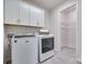 Functional laundry room includes ample storage cabinets and modern washer and dryer set at 1636 Red Leaf Dr, Fort Mill, SC 29715