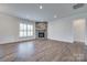 Living room features a stone fireplace, dark hardwood floors and white trim at 1636 Red Leaf Dr, Fort Mill, SC 29715