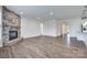 Bright living room with a stone fireplace and wood floors at 1636 Red Leaf Dr, Fort Mill, SC 29715