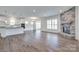 Open-concept living room featuring a fireplace and hardwood floors at 1636 Red Leaf Dr, Fort Mill, SC 29715