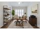 This staged office space features a light colored rug and shutters on the bright windows at 1636 Red Leaf Dr, Fort Mill, SC 29715