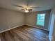 Cozy bedroom featuring stylish, wood-look flooring and a modern ceiling fan for optimal comfort at 1820 Wendover Dr, Lancaster, SC 29720