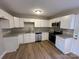 Modern kitchen with white cabinets, granite countertops, and stainless steel appliances at 1820 Wendover Dr, Lancaster, SC 29720