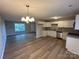 Bright kitchen featuring white cabinets, stainless steel appliances, and hardwood flooring at 1820 Wendover Dr, Lancaster, SC 29720