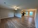 Open-concept living space features a ceiling fan, hardwood floors, and lots of natural light at 1820 Wendover Dr, Lancaster, SC 29720