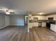 Open-concept living space features a ceiling fan, hardwood floors, and lots of natural light at 1820 Wendover Dr, Lancaster, SC 29720