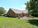 Grassy backyard with a brick patio and mature landscaping at 202 Cameron Dr, Kings Mountain, NC 28086