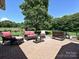 Brick patio with lounge seating and a large tree offering ample shade at 202 Cameron Dr, Kings Mountain, NC 28086