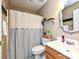 Bright bathroom featuring shower with curtain, oak vanity, and an oval mirror at 202 Cameron Dr, Kings Mountain, NC 28086