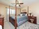 Bedroom with a four-poster bed, ceiling fan, side tables, and neutral walls at 202 Cameron Dr, Kings Mountain, NC 28086