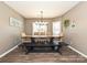 Formal dining room with a modern light fixture, neutral walls, and stylish seating at 202 Cameron Dr, Kings Mountain, NC 28086