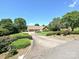 Well-manicured lawn with a long driveway leading to a beautiful brick home surrounded by trees at 202 Cameron Dr, Kings Mountain, NC 28086