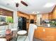 A well lit kitchen is open to the breakfast nook and features granite countertops and wood cabinets at 202 Cameron Dr, Kings Mountain, NC 28086