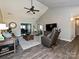 Comfortable living room featuring wood floors, vaulted ceiling, and a view into adjacent rooms at 202 Cameron Dr, Kings Mountain, NC 28086