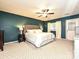 This cozy main bedroom features an upholstered headboard, ceiling fan, and neutral walls at 202 Cameron Dr, Kings Mountain, NC 28086