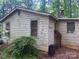 Exterior view of home that needs TLC, with peeling paint, surrounded by trees at 2206 Meadow Rd, Clover, SC 29710