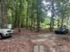 View of lot surrounded by trees with Explorer, Pickup truck and Black Sedan at 2206 Meadow Rd, Clover, SC 29710