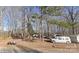 Picturesque property nestled amongst mature trees, a cozy single-story home, and multiple recreational vehicles at 2206 Meadow Rd, Clover, SC 29710
