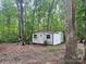 View of lot surrounded by trees with storage shed with windows and door at 2206 Meadow Rd, Clover, SC 29710