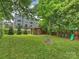 Backyard features a fire pit, play area, and mature trees, creating a park-like setting at 2222 Wilmore Dr, Charlotte, NC 28203