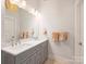 Bathroom boasts double sinks, quartz countertop, and elegant lighting at 2222 Wilmore Dr, Charlotte, NC 28203