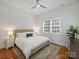 Inviting bedroom featuring a cozy bed, hardwood floors, and natural light at 2222 Wilmore Dr, Charlotte, NC 28203