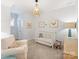 Inviting Bedroom with a crib, chandelier, and soft, neutral tones creating a serene atmosphere at 2222 Wilmore Dr, Charlotte, NC 28203