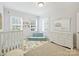 Bright bedroom featuring two windows, a crib and a daybed, complete with carpeted floors at 2222 Wilmore Dr, Charlotte, NC 28203
