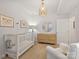 Cozy Bedroom featuring a crib, dresser, and comfortable seating, perfect for relaxation and childcare at 2222 Wilmore Dr, Charlotte, NC 28203