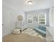 Bright bedroom featuring two windows, a crib and a daybed, complete with carpeted floors at 2222 Wilmore Dr, Charlotte, NC 28203
