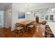 Stylish dining room featuring a rustic wood table, views of the front entrance, and a coffered ceiling at 2222 Wilmore Dr, Charlotte, NC 28203