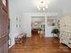 Inviting foyer with hardwood floors, elegant lighting, and bench seating with a view into the dining room at 2222 Wilmore Dr, Charlotte, NC 28203