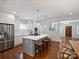 Spacious kitchen featuring a large island with seating and view to the dining and living room at 2222 Wilmore Dr, Charlotte, NC 28203