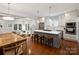 Open-concept kitchen with a large island, bar seating, and stainless steel appliances flowing into the living room at 2222 Wilmore Dr, Charlotte, NC 28203