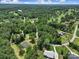 Expansive aerial view shows the house, golf course, pond, and other homes nestled among lush greenery at 263 Fairway Cir, Rock Hill, SC 29730