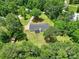 Drone shot of a home with a private driveway, nestled among a dense canopy of trees at 263 Fairway Cir, Rock Hill, SC 29730