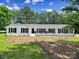 Quaint home with black shutters surrounded by landscaped yard, creating a welcoming atmosphere at 263 Fairway Cir, Rock Hill, SC 29730