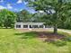 Charming white home featuring a well-manicured lawn and large tree for added curb appeal at 263 Fairway Cir, Rock Hill, SC 29730