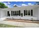 Charming front porch with white brick, black shutters, black door, and space for seating at 263 Fairway Cir, Rock Hill, SC 29730