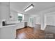 Bright, all-white kitchen featuring stainless steel appliances, wood floors, and modern lighting at 263 Fairway Cir, Rock Hill, SC 29730