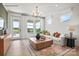 Bright living room featuring hardwood floors, neutral-colored walls, large windows and a decorative rug at 2658 Headwind Ct # 245, Belmont, NC 28012