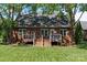 Brick home with deck and stairs, surrounded by lush green lawn at 3124 17Th Street Ne Ln, Hickory, NC 28601