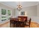 Well-lit dining room featuring hardwood floors, a large window, and a classic dining set at 3124 17Th Street Ne Ln, Hickory, NC 28601
