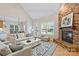 Cozy living room featuring a brick fireplace, wood floors and an open floorplan at 3124 17Th Street Ne Ln, Hickory, NC 28601