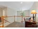 Open upstairs hallway featuring natural light from a beautiful chandelier and desk at 3124 17Th Street Ne Ln, Hickory, NC 28601