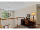 Bright upstairs hallway with a desk area, chandelier, and staircase view at 3124 17Th Street Ne Ln, Hickory, NC 28601