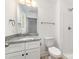 Bright bathroom features a granite countertop, white cabinets, and a walk-in shower at 314 Adams St, Salisbury, NC 28144